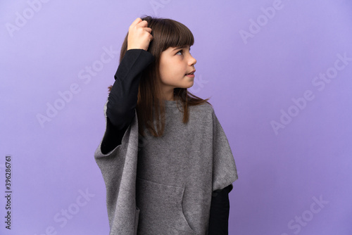 Little girl over isolated background having doubts while scratching head