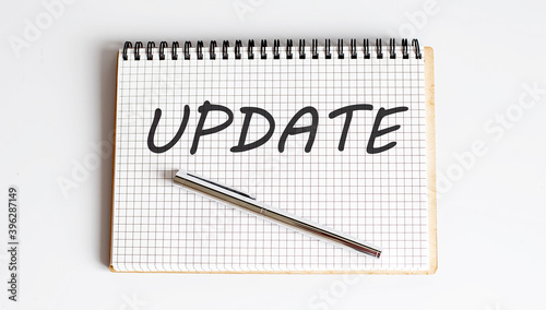 Wallpaper Mural Business concept. Notebook with text UPDATE in the white background Torontodigital.ca