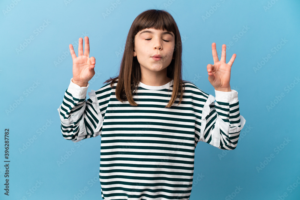 Little girl over isolated background in zen pose Little girl over isolated background in zen pose