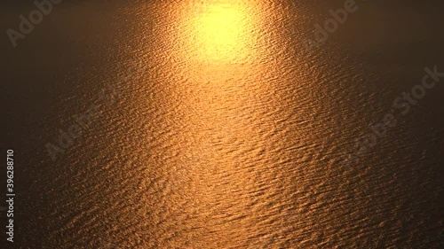 Sunlights Over the Sea Surface. Sunset over the sea. Yellow, orange and red tone colors. The Novaya Zemlya effect is a polar mirage caused by high refraction of sunlight between atmospheric thermal 4K