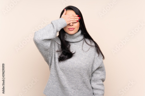 Young Colombian girl over isolated background covering eyes by hands. Do not want to see something © luismolinero