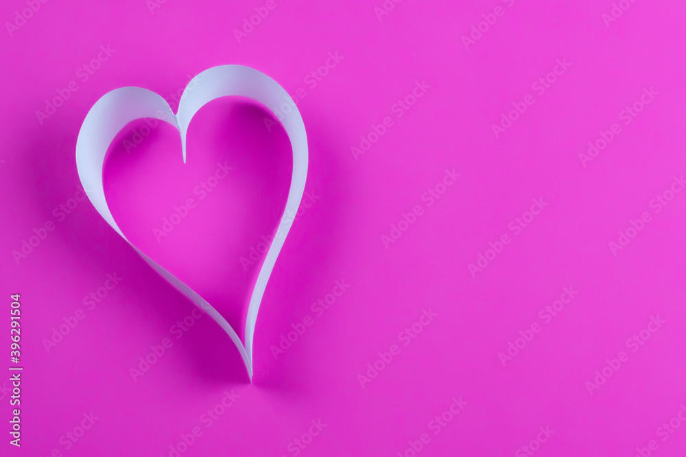 paper ribbon heart on pink background