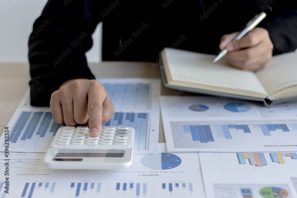 professional business person working on a calculator professional business person working on a calculator
