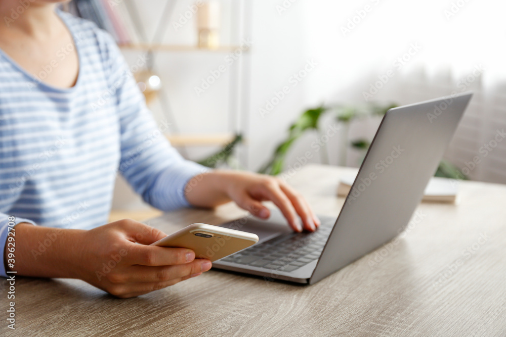 Work from home concept. Cropped shot of woman's hands typing on laptop. Female freelancer working at her living room. Close up, copy space for text. Work from home concept. Cropped shot of woman's hands typing on laptop. Female freelancer working at her living room. Close up, copy space for text.
