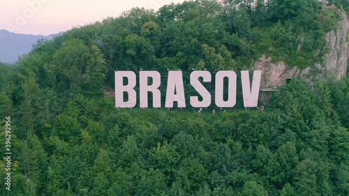 Brasov symbol sign on top of the Tampa mountain. Big white letters in the mountain forest. Old city Brasov, Kronstadt, Romania. Aerial view of Brasov sign on the hill.