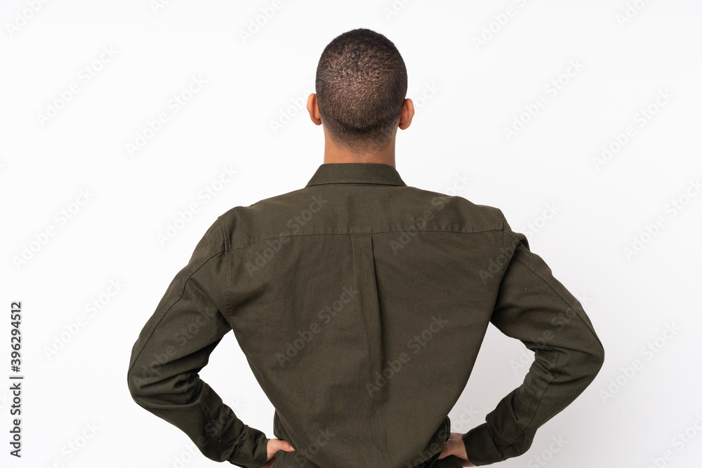 Young African American man over isolated white background in back position Young African American man over isolated white background in back position