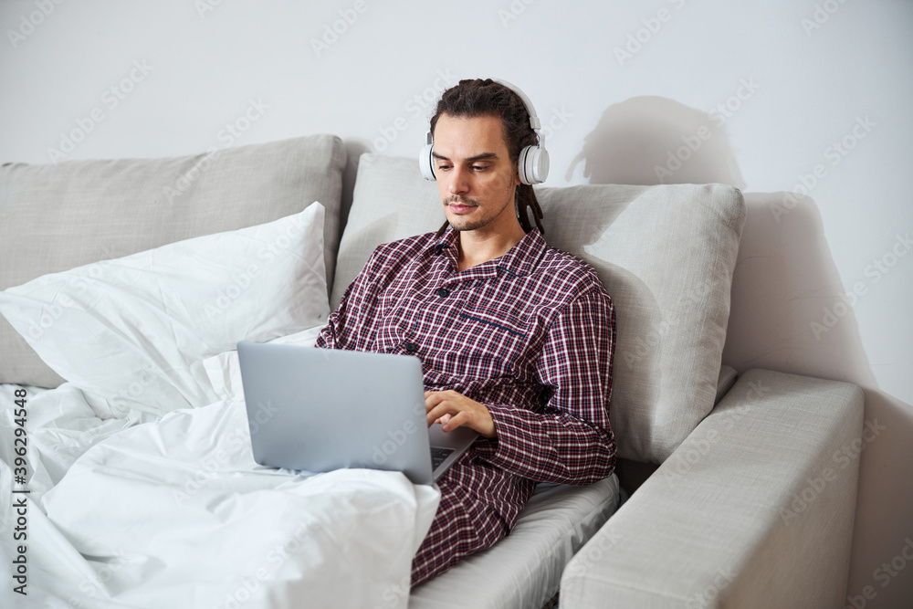 Handsome young man using modern laptop at home Handsome young man using modern laptop at home
