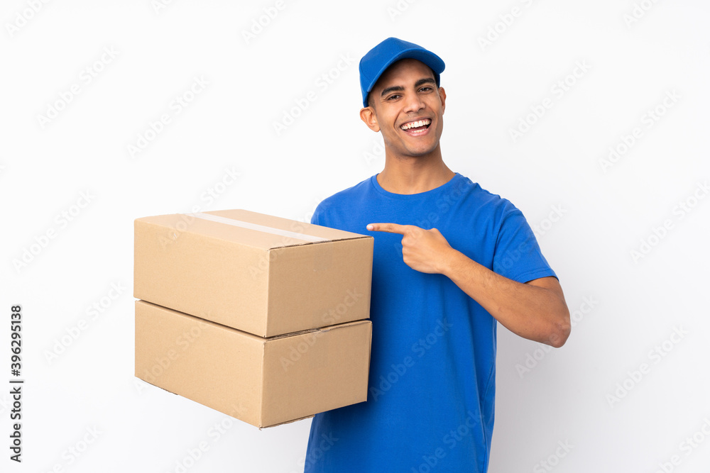 Delivery man over isolated white background and pointing it Delivery man over isolated white background and pointing it