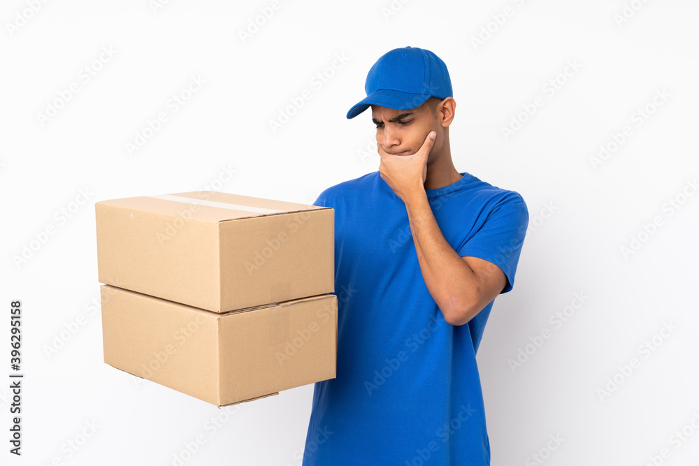 Delivery man over isolated white background with sad expression Delivery man over isolated white background with sad expression