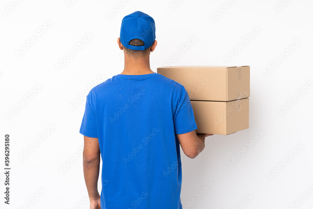 Delivery man over isolated white background in back position Delivery man over isolated white background in back position