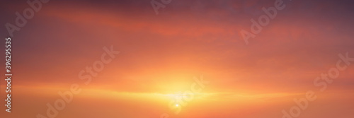background of cloudscape at the sunset with sunshine on sky and red clouds © mimadeo