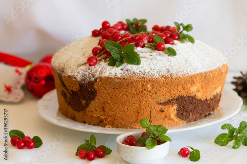 christmas chiffon cake with chocolate, powdered sugar, currant and mint