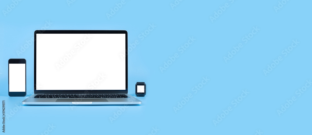 Mockup image computer, smart watch, cell phone with blank screen for typing text in workplace on desk at office. Conception design creative work space on blue background. Modern digital devices Mockup image computer, smart watch, cell phone with blank screen for typing text in workplace on desk at office. Conception design creative work space on blue background. Modern digital devices