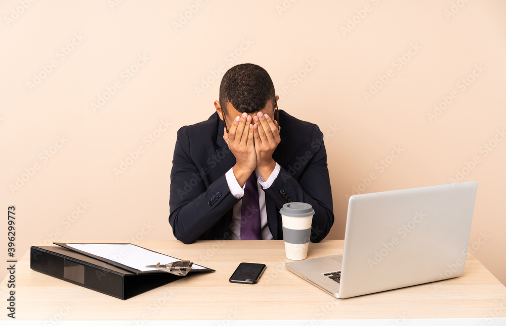 Young business man in his office with a laptop and other documents with tired and sick expression Young business man in his office with a laptop and other documents with tired and sick expression