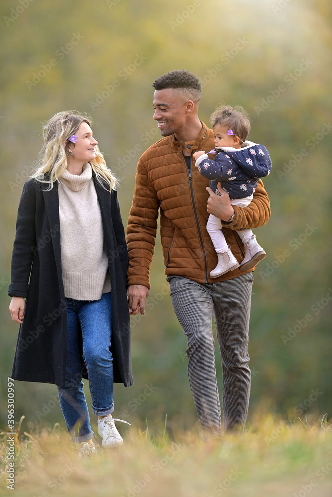 Young family walking together outside in countryside