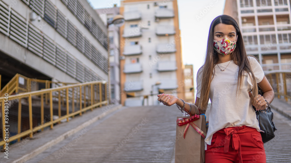 Obraz premium Latin woman doing Christmas shopping with protective mask