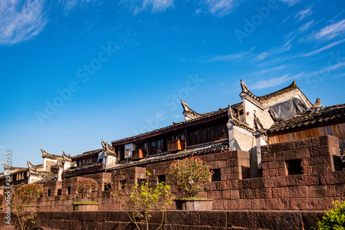 Tourists walking along Phoenix Ancient Town (Fenghuang County). Awesome view of scenic old street. Fenghuang is a popular tourist destination of Asia.