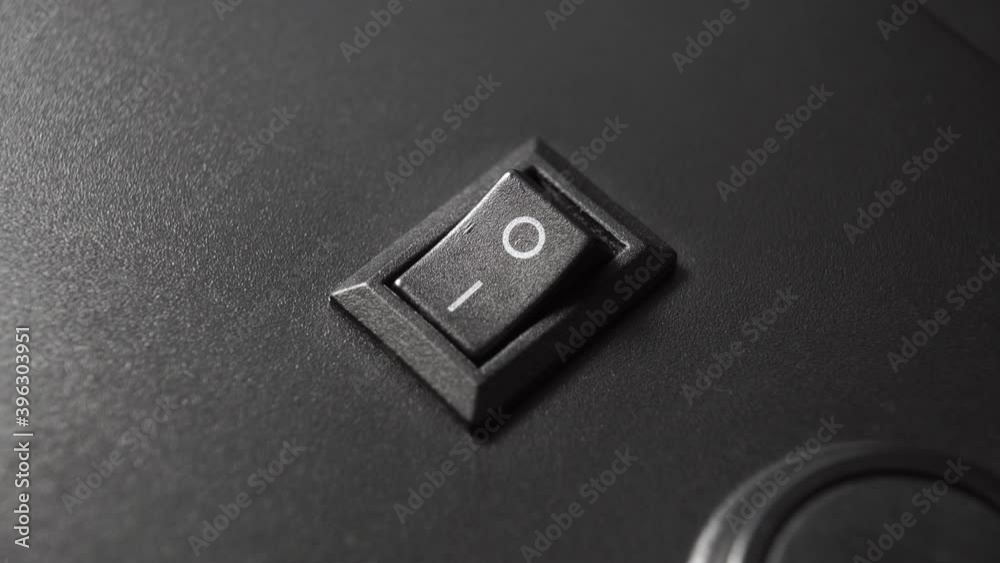 Closeup black switch in the ON position on the plastic control panel of the electrical appliance. Rotation. Closeup black switch in the ON position on the plastic control panel of the electrical appliance. Rotation.