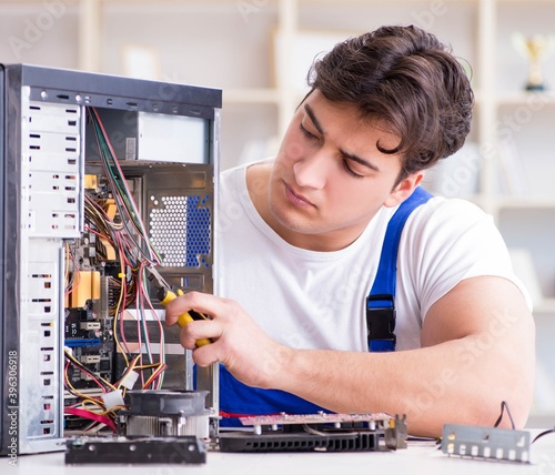 Wallpaper Mural Computer repairman repairing desktop computer Torontodigital.ca