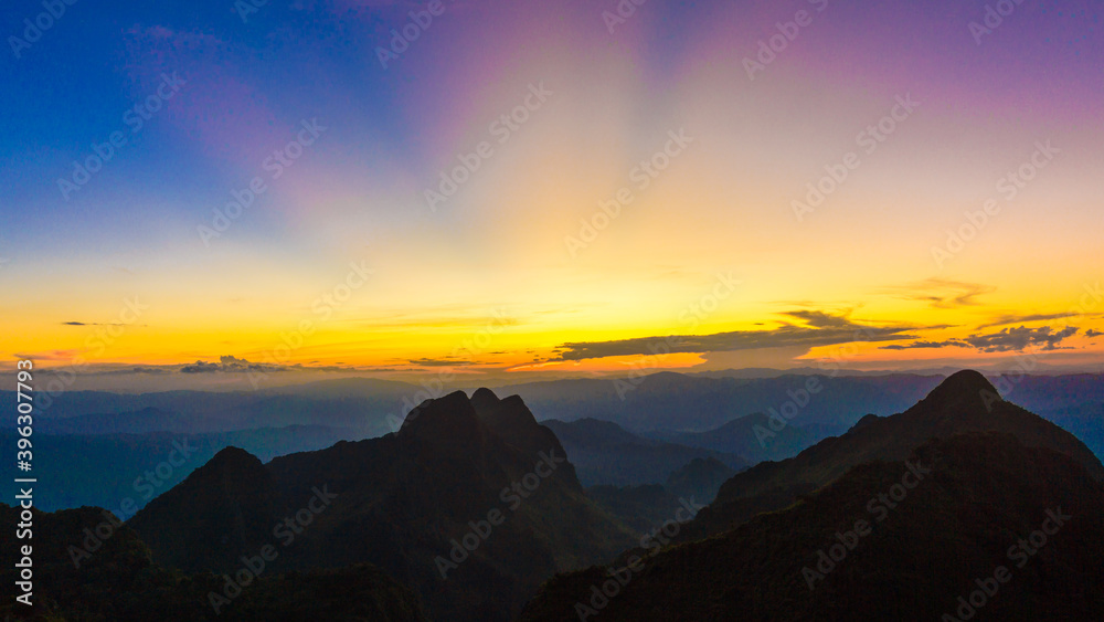 Top of mountain silhouette sunset with colorful sky cloud