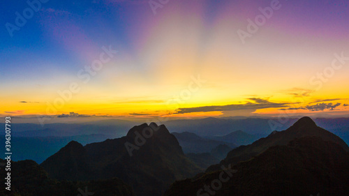 Top of mountain silhouette sunset with colorful sky cloud