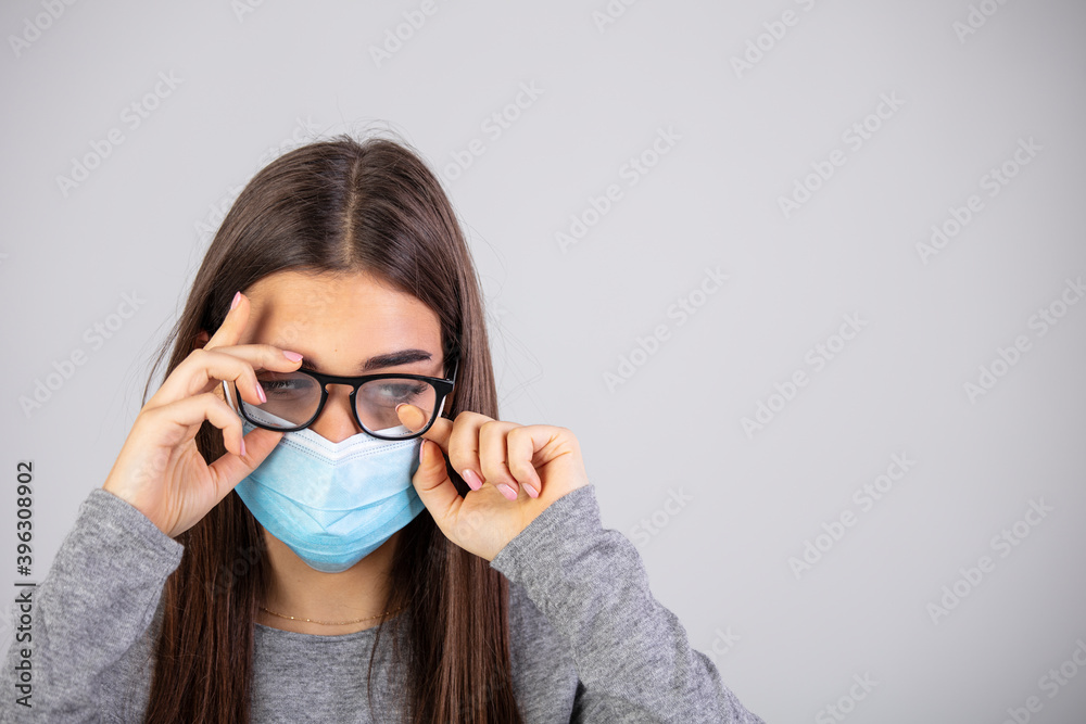 Woman wearing surgical mask due to the pandemic but its cause the fogging of the glasses. Problem of fogging of the glasses due to the wearing of the surgical mask. Woman wearing surgical mask due to the pandemic but its cause the fogging of the glasses. Problem of fogging of the glasses due to the wearing of the surgical mask.