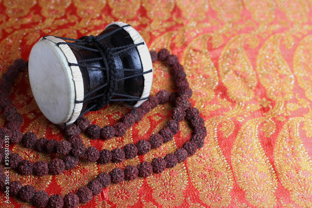 traditional hindu prayer beads rudraksha and musical instrument of God Shiva Damaru drum on a