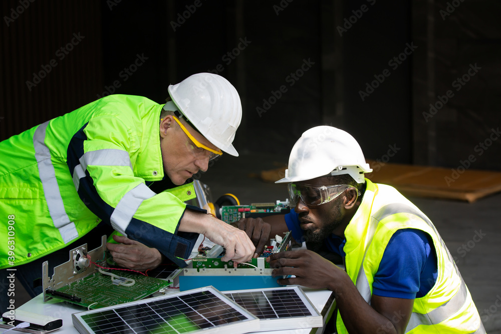 Technician checking on solar cell control panel. Technician checking on solar cell control panel.
