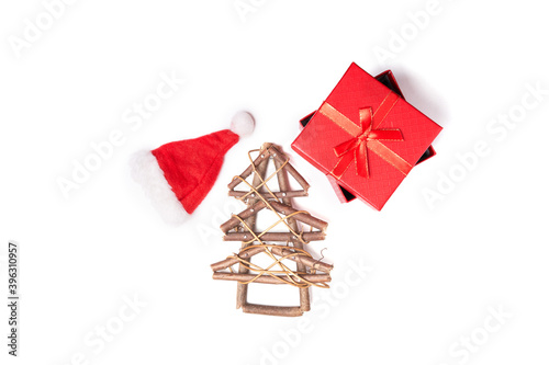 Wooden Christmas tree, hat and gift on white isolated background