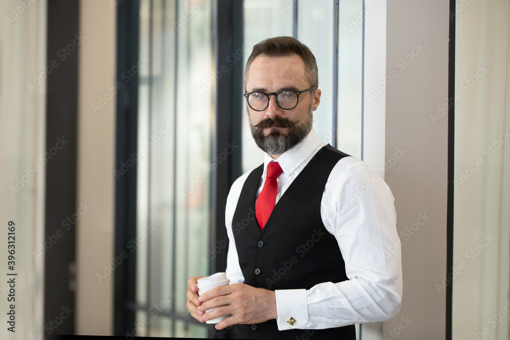 Bearded hipster businessman holding coffee cup portraits. Bearded hipster businessman holding coffee cup portraits.
