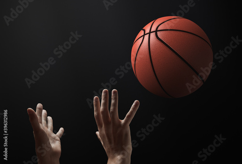 Basketball theme. The moment the ball is thrown. There are only hands and a ball in the frame © Happyphotons
