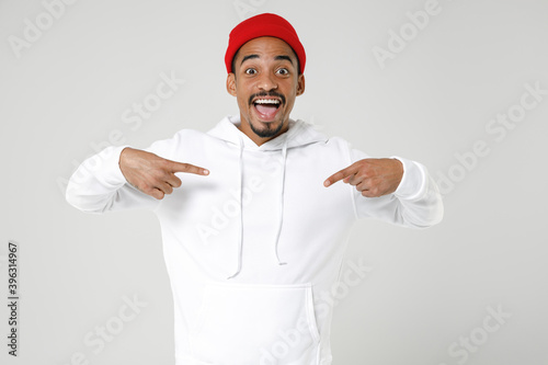Cheerful excited young african american man 20s years old wearing casual basic streetwear hoodie standing pointing index fingers on himself isolated on white colour wall background studio portrait.