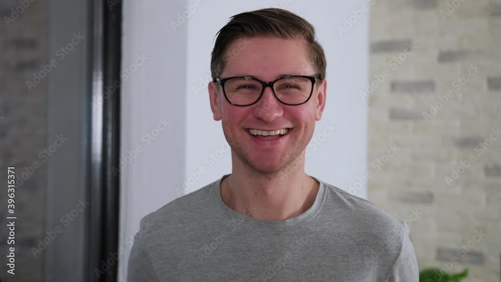 Handsome man wearing glasses and smiling cheerful with confident smile on face.