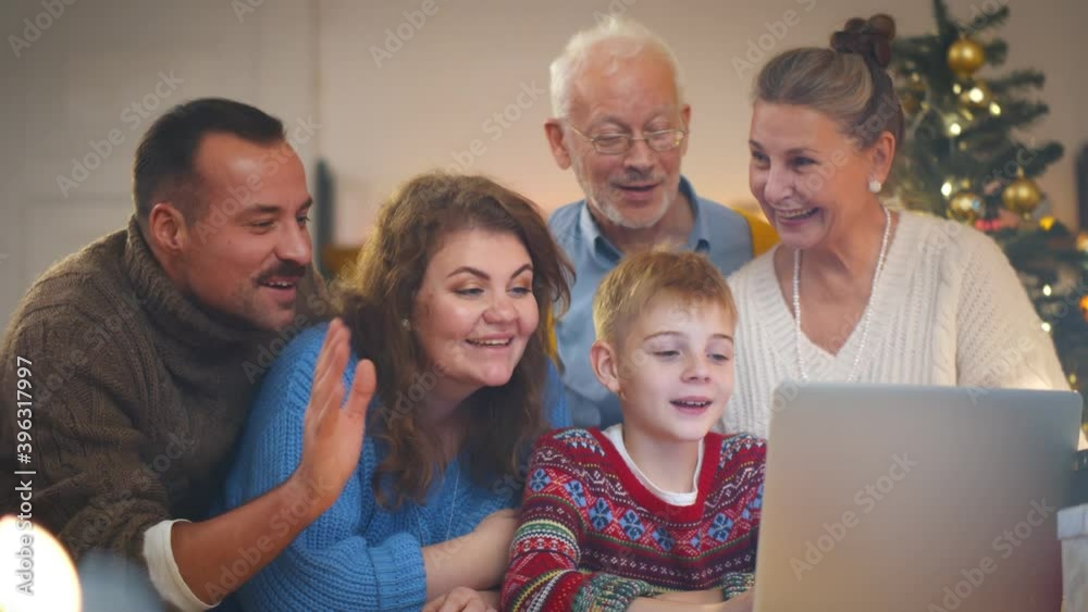 Happy caucasian family having video call using laptop celebrating christmas at home