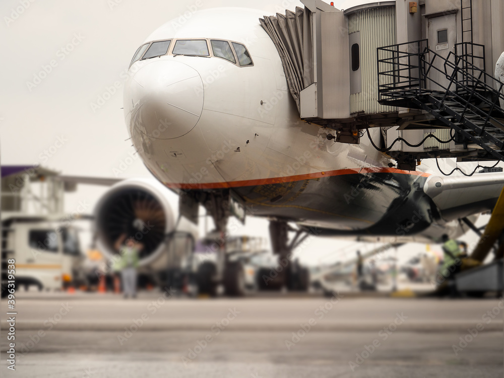 Airplane near the terminal in an airport Airplane near the terminal in an airport