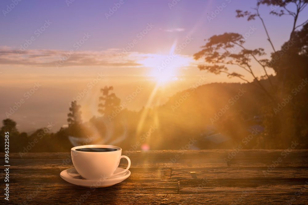 Close up coffee cup on wood table at sunset or sunrise background. Close up coffee cup on wood table at sunset or sunrise background.