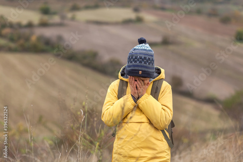 Depressed little hiker in autumn day on a hill.
