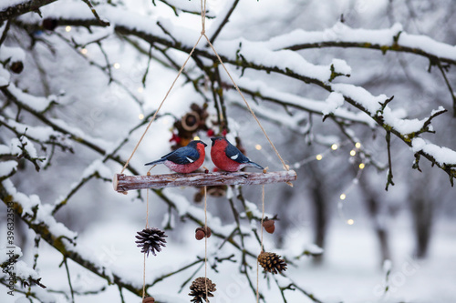 handmade christmas and new year decor with wooden birds bullfinches and natural materials.creative home and garden decor for winter holidays