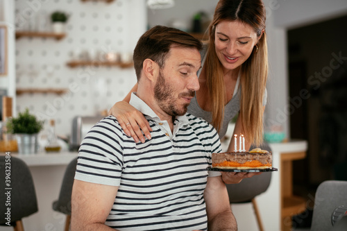 Husband s birthday. Wife surprise her husband with birthday cake.