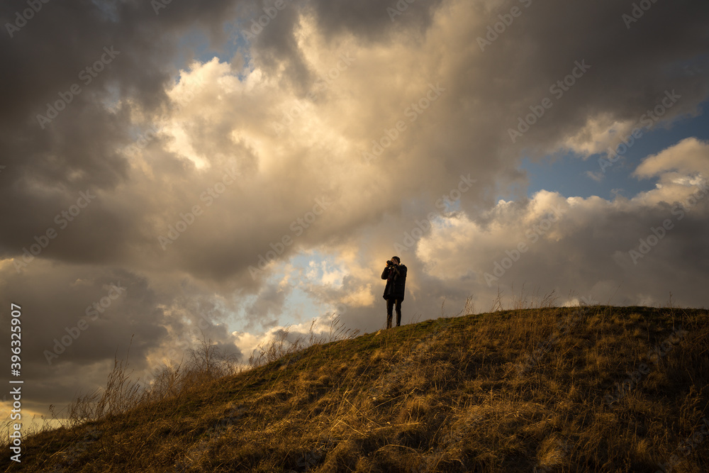 silhouette of a person on a hill