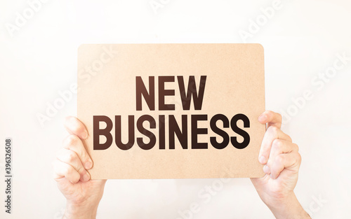 Closeup Business man hand holding show blank paper sheet mock up empty white board space for shouting text rule or protest word. Text New Business