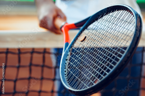 Tennis racket and tennis net on tennis court photo
