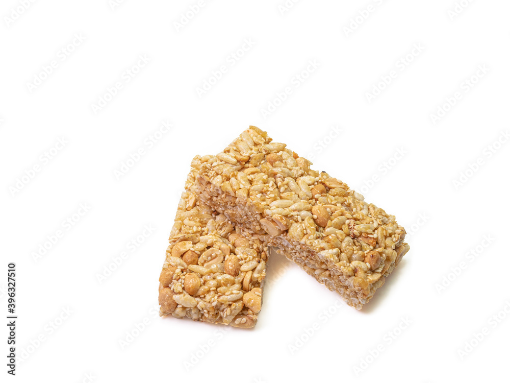 The close up of homemade Thai sweet cereal bar candy on white background, traditional muesli food in thailand.