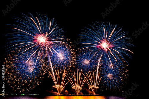 The color and beautiful of fireworks set up in the sea, in the black sky at night time, for celebrating the holidays festival, to people and Happy New Year concept.