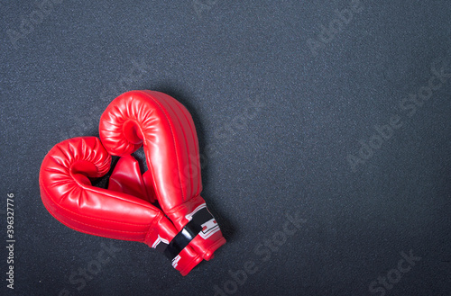 Gym background and fitness equipment and valentine concept. Boxing glove in shape of heart. © Наталия Денисова
