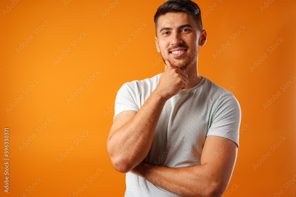 Young positive man in white casual shirt standing with happy smile Young positive man in white casual shirt standing with happy smile