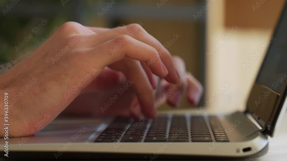 Close up shot of male hands typing on laptop while sitting at office desk indoors. Man fingers tapping and texting on computer keyboard while working in cabinet. Close up shot of male hands typing on laptop while sitting at office desk indoors. Man fingers tapping and texting on computer keyboard while working in cabinet.