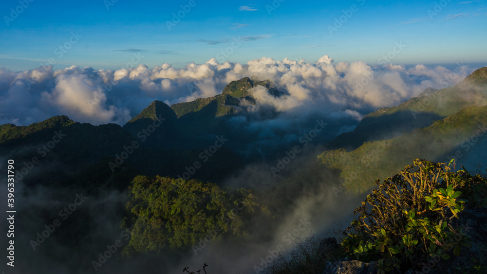 Morning sunrise with fog on top of mountain blue sky vacation trekking winter