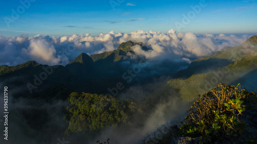 Morning sunrise with fog on top of mountain blue sky vacation trekking winter