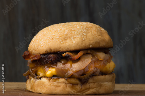 Delicious Cheddar Cheese Burger with Caramelized Onions and Bacon
